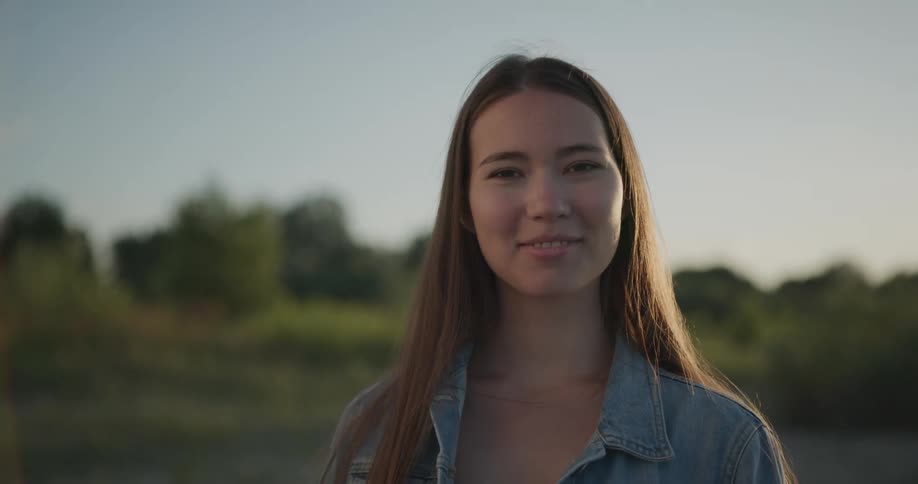 A woman standing outside smiling at the camera