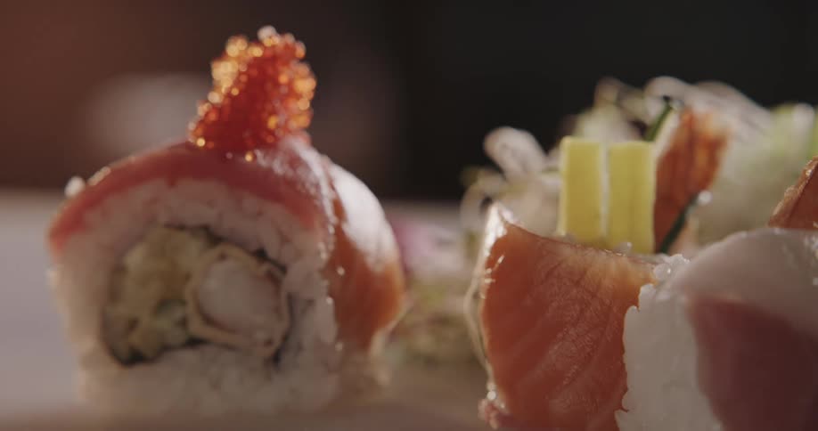 A person is eating sushi indoors