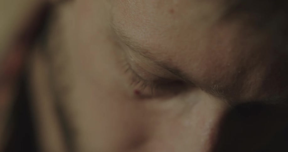 A man in a room looking downward