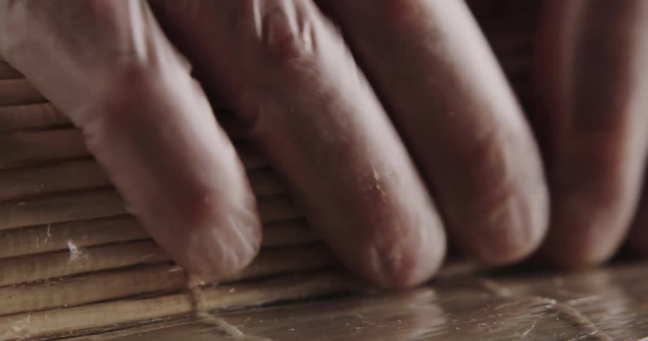 A person is packaging fish while wearing gloves
