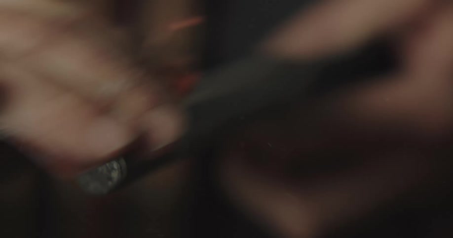A man uses his fingers to buff a metal handle