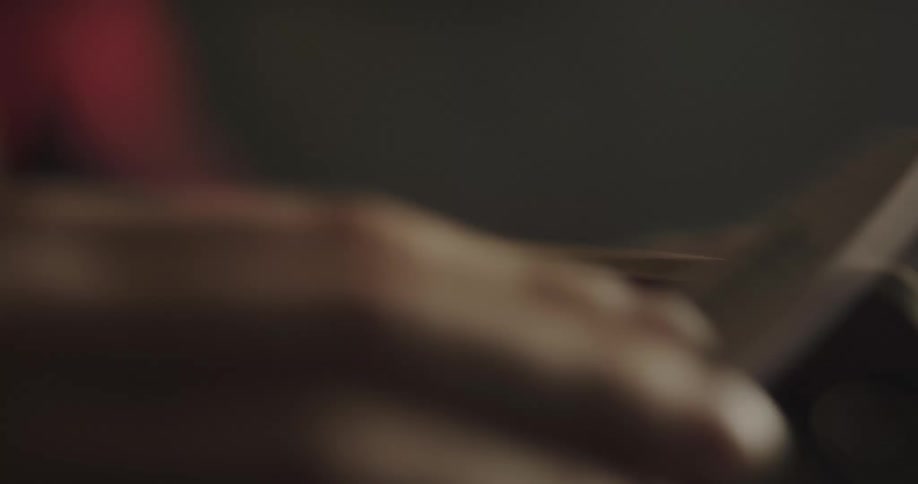 A person sanding a handle indoors