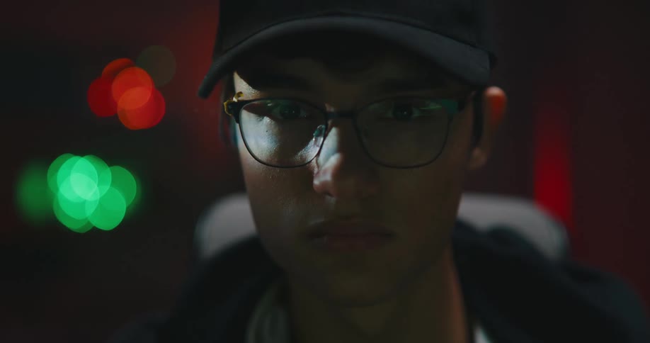 A teenage boy turns his head and looks forwards
