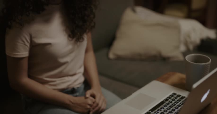 A woman talking to a laptop