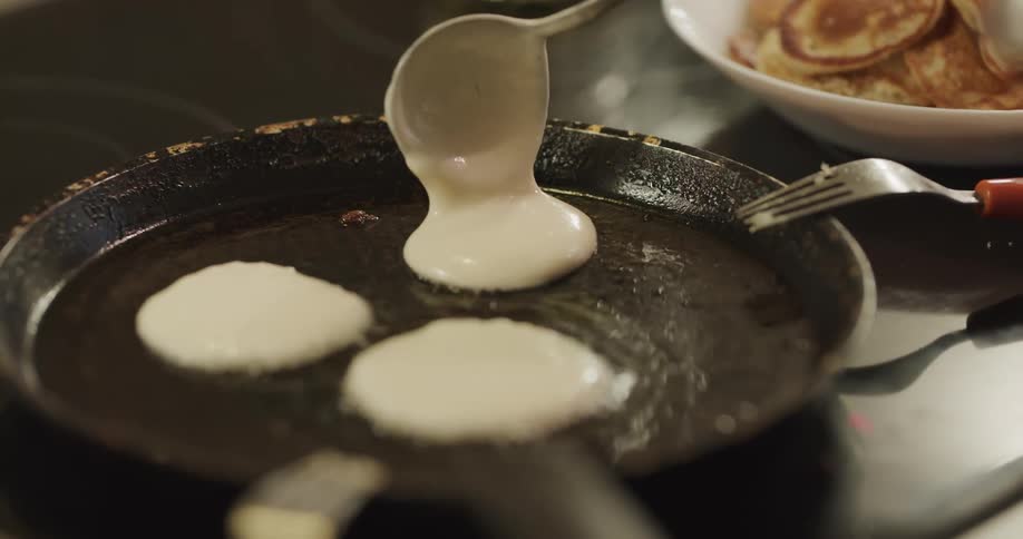 Silver dollar pancakes are made on a cast iron grill