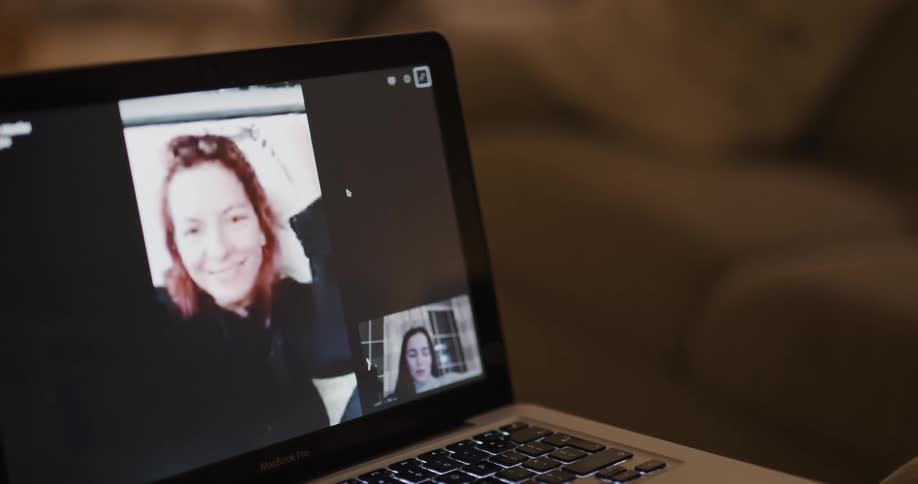 Woman makes a video call with woman on laptop in the living room at home