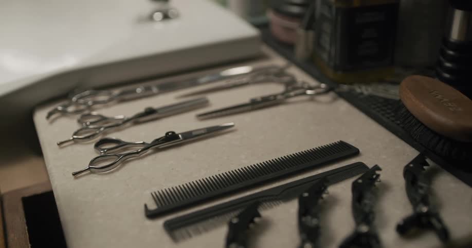 A person reaching for a comb on a table