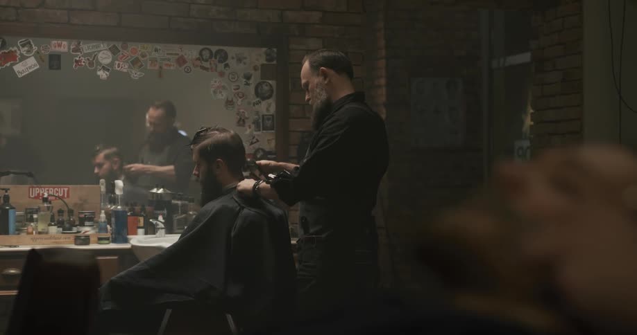 A barber cutting a clients hair