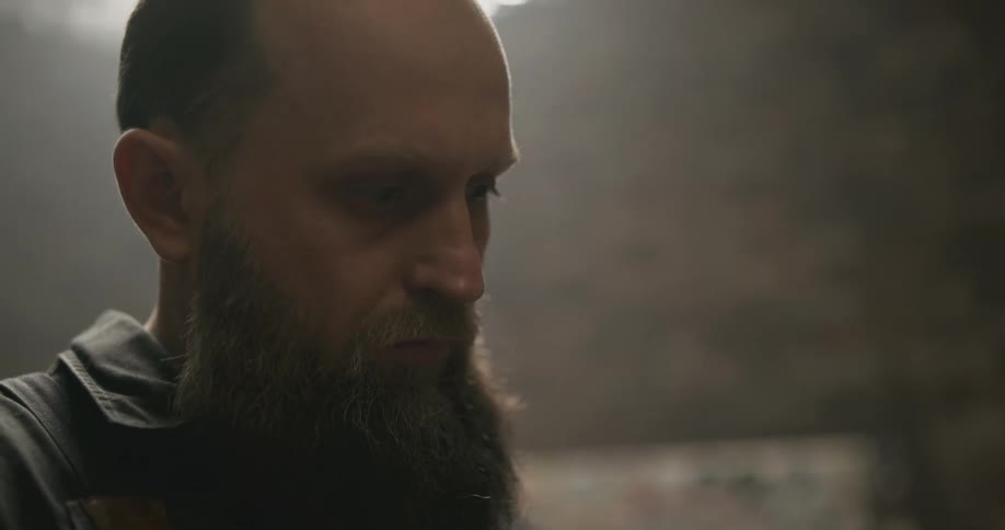 A man looks at his work as he paints
