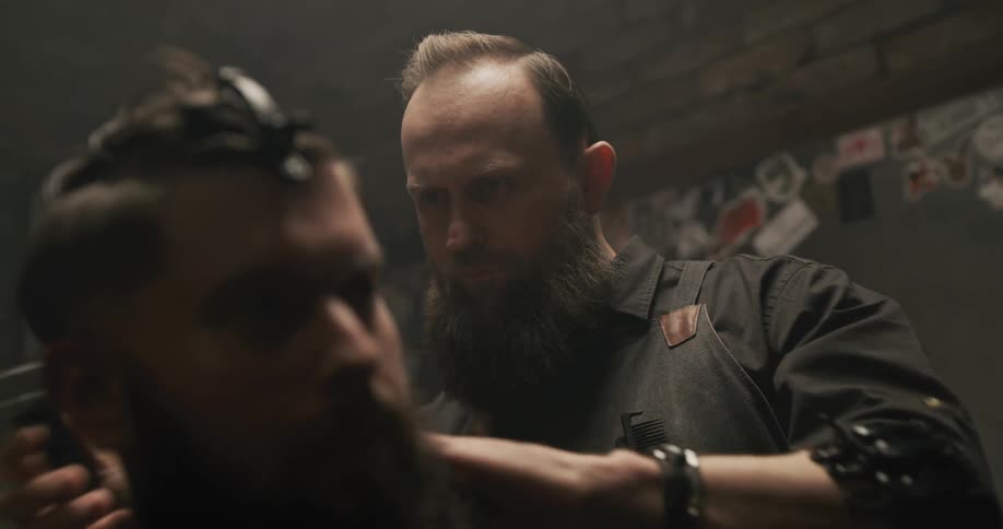 A barber cutting a mans hair