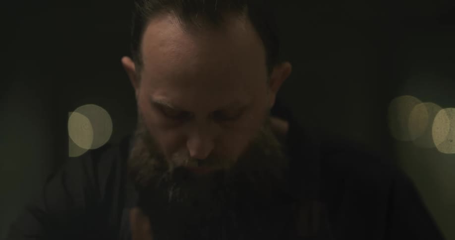A barber trims a mans moustache