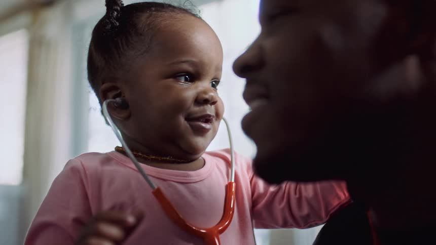 A daughter and father are interacting together indoors