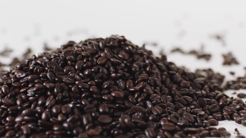Pile of coffee beans with some scattered around