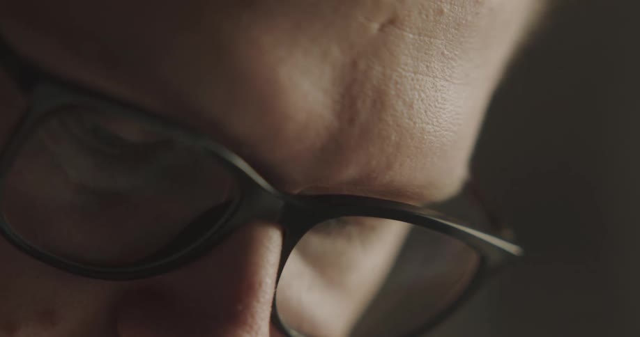 A close up of a man with glasses