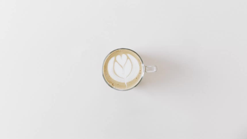 A cream design on a cup of coffee against a white background
