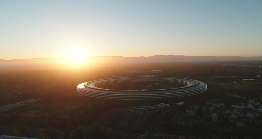 Modern futuristic round building with bright sunlight shining on it