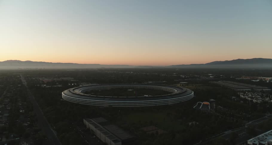 A large ring shaped stadium sits in the middle of a suburb