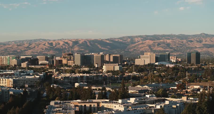 Midsize city in a sunny day with mountains at the background