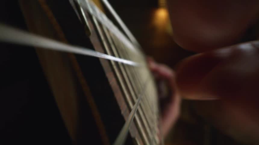 A person is playing the string guitar
