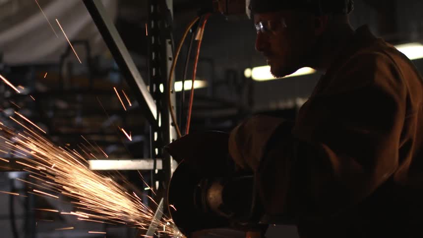 A man is using a circular saw in a shop