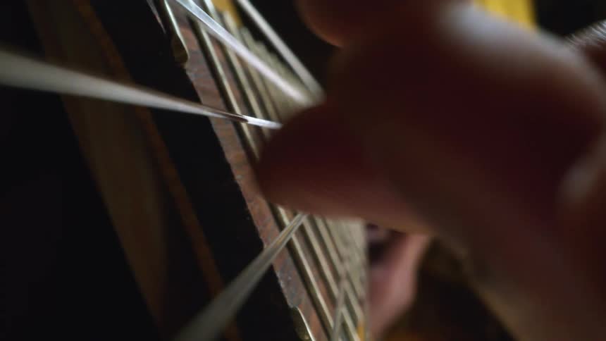 A close up of a person playing a guitar