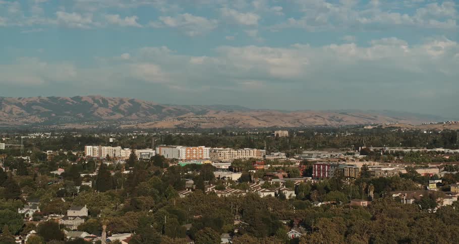An aerial view of a skyline with vehicles driving in the distance