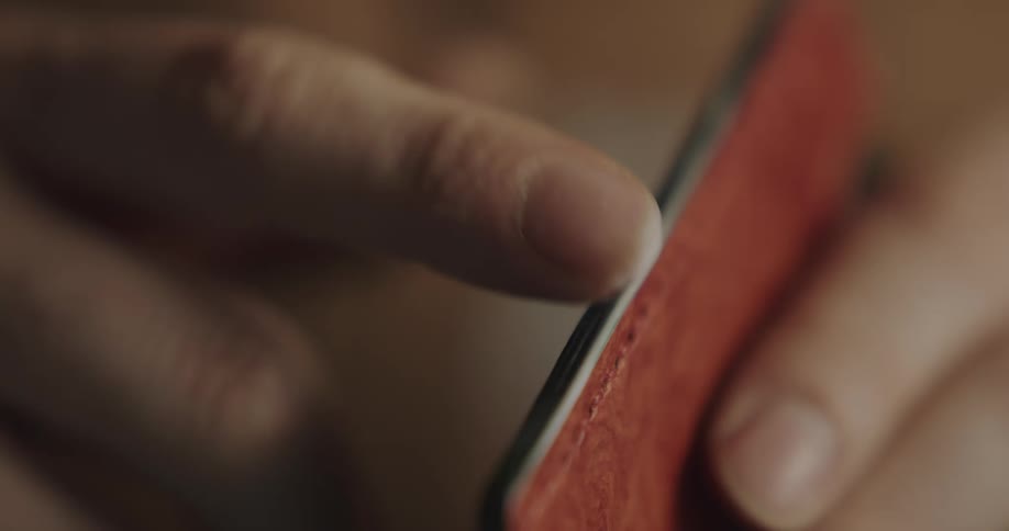 Person uses fingertips to glue pieces of handcrafted leather together