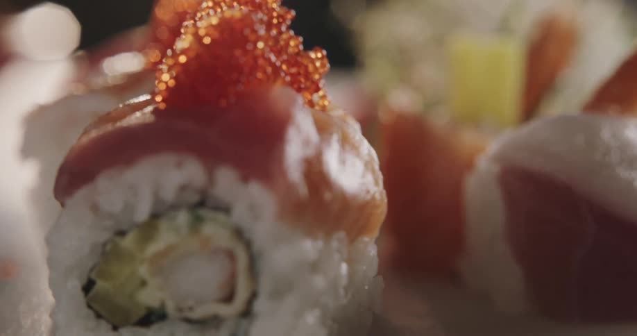 Close up shot of sushi rolls on display