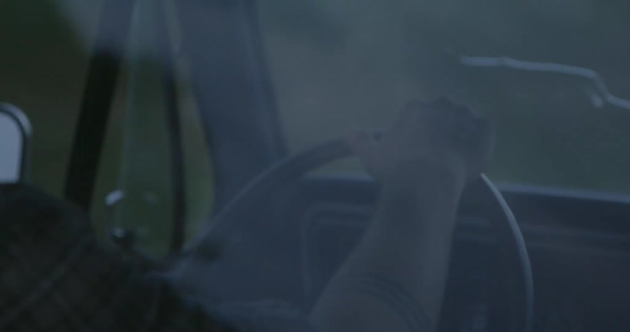 A man driving a truck down a road