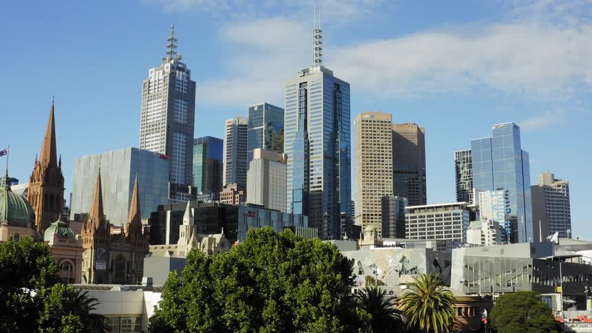 Tall city buildings with modern architecture and many other buildings around on a cloudy day
