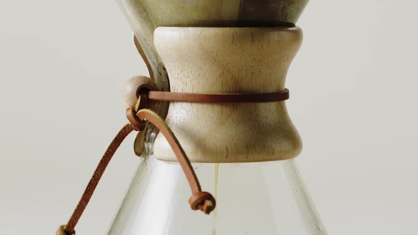 Coffee dripping in a coffee maker with a white background