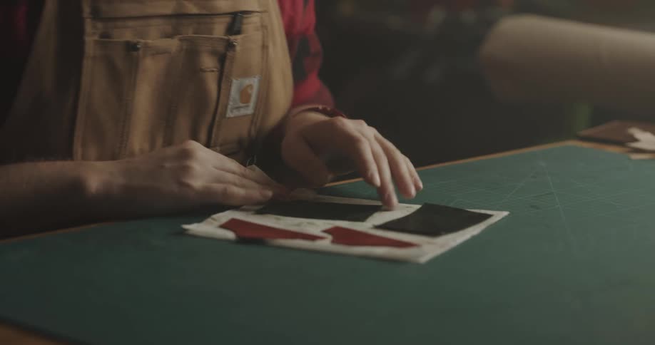 A man cleaning off leather in a shop