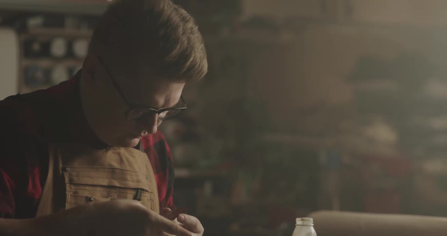 An employee cleaning some tile in a studio