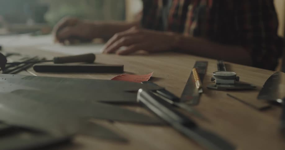 A person is writing on paper in a shop