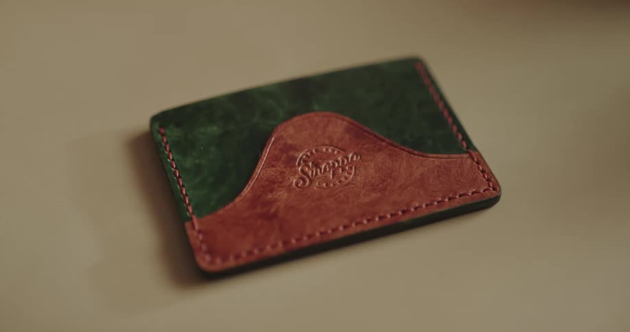 A leather wallet on a white table