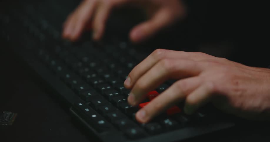 Someone is typing on a keyboard with both hands