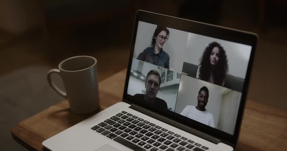 A video call on a laptop with 4 people