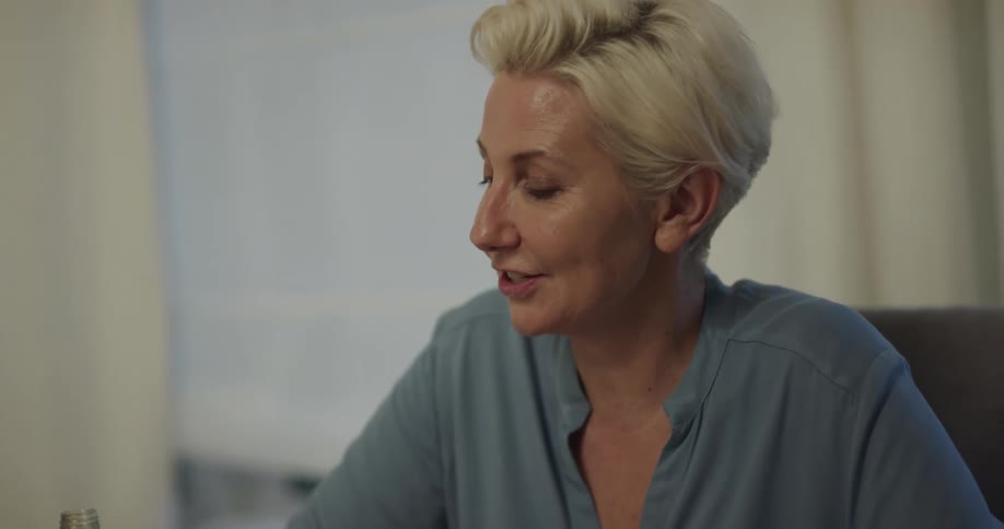 A woman sitting and laughing