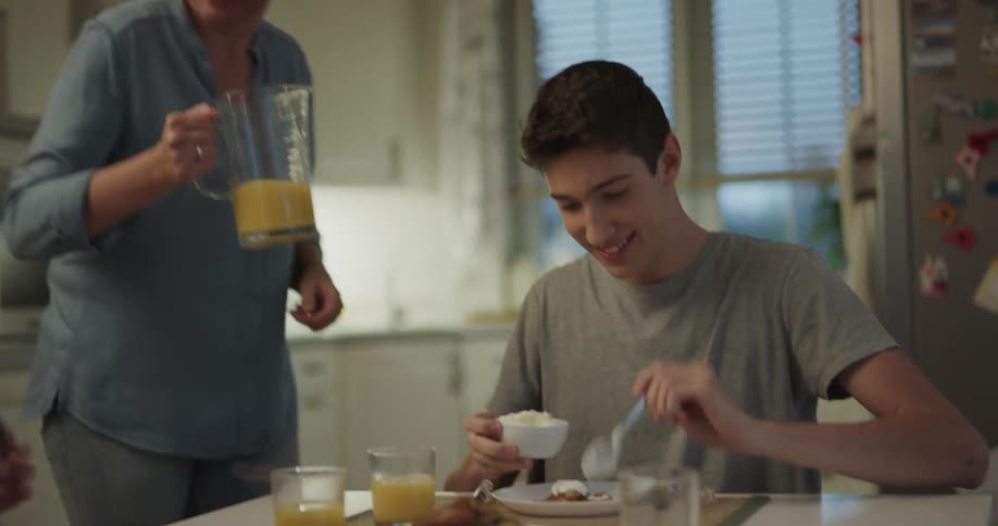 Grandmother serving breakfast to grand kids in the morning