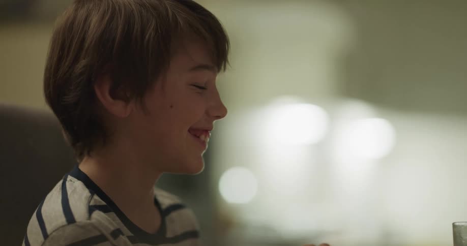 A child smiling and laughing at something