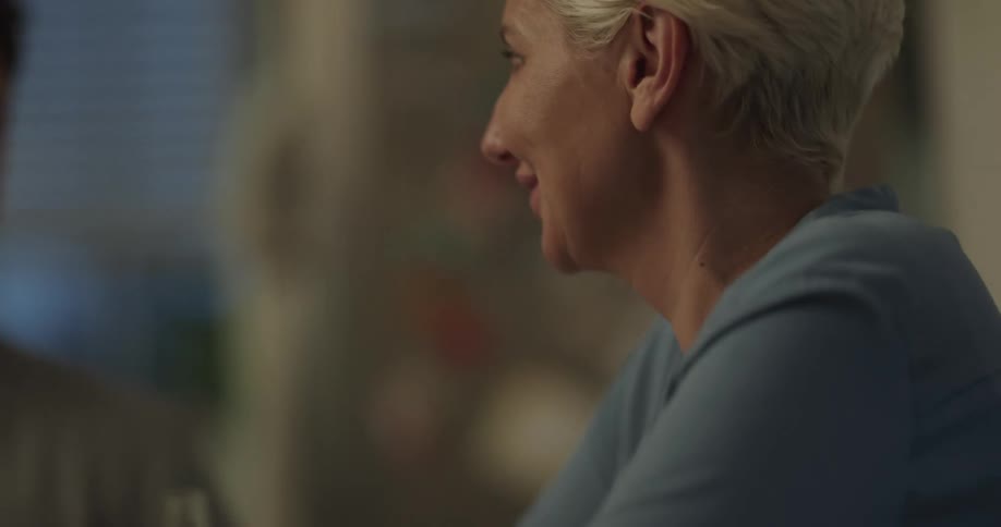 Woman sits smiling and talking