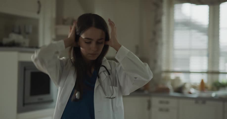 A doctor puts on her jacket and stethoscope then checks her phone and drinks coffee before leaving for work