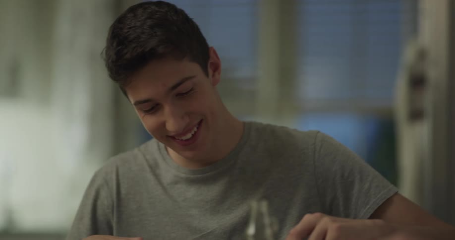 Mother and son having dinner together at home while chatting and laughing