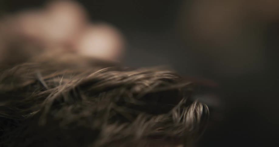 A barber combs a mans hair