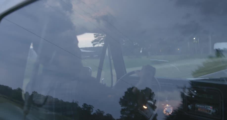 White man driving his car at a residential area