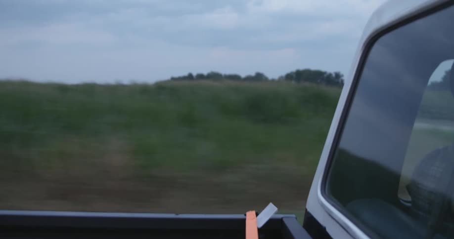 A shot of a truck and farmland