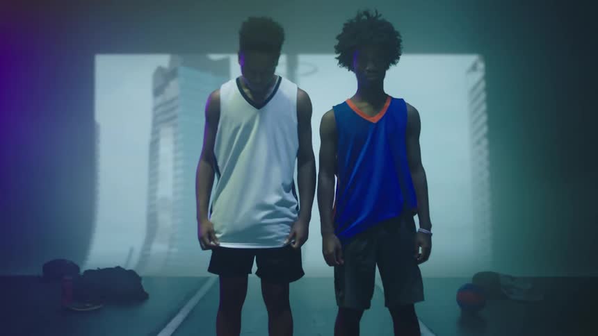 Two men pose on stage in front of a projector image
