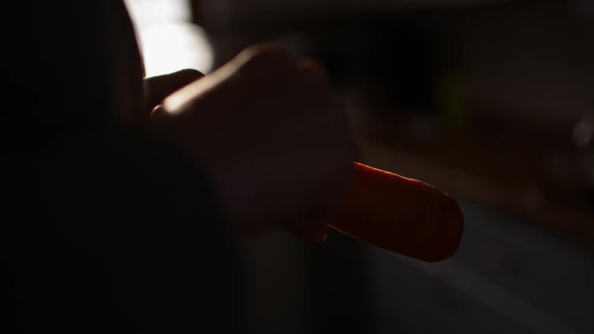 Close up of a carrot being peeled