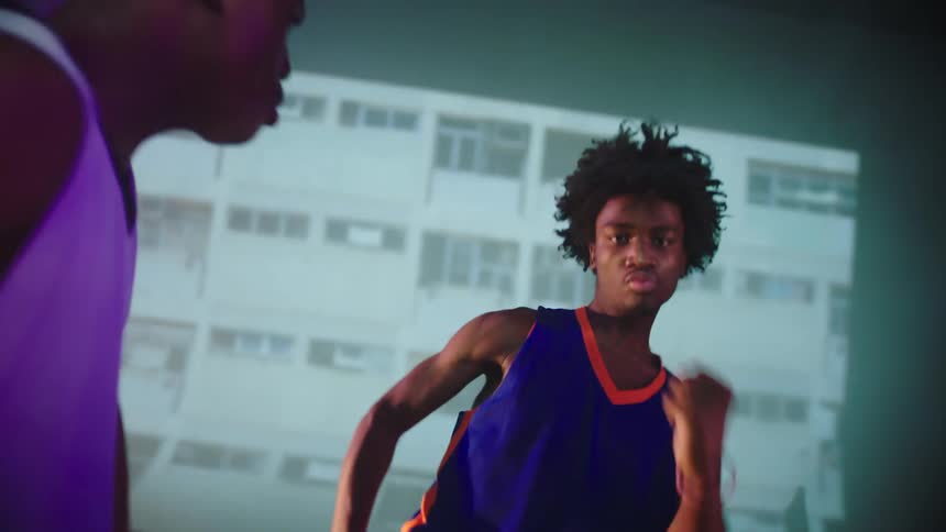 Two people in jerseys dancing in front of a projector screen