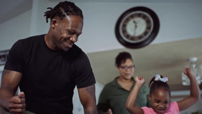 A family dancing together in their house